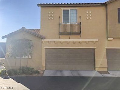 View of front of home with driveway, stucco siding