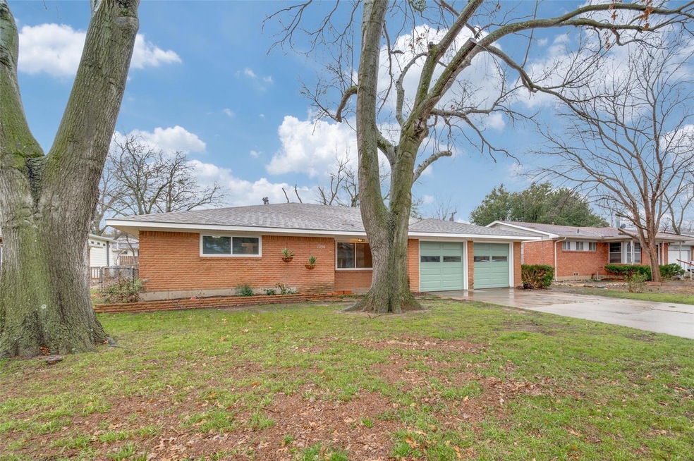 Ranch-style home with a front lawn and a garage