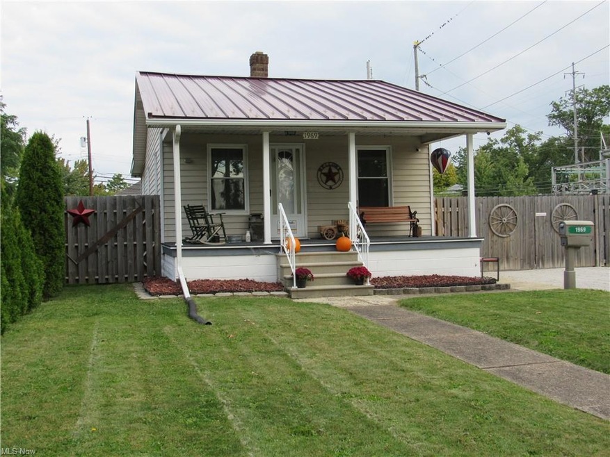 Front of home. Metal roof. Large covered front por
