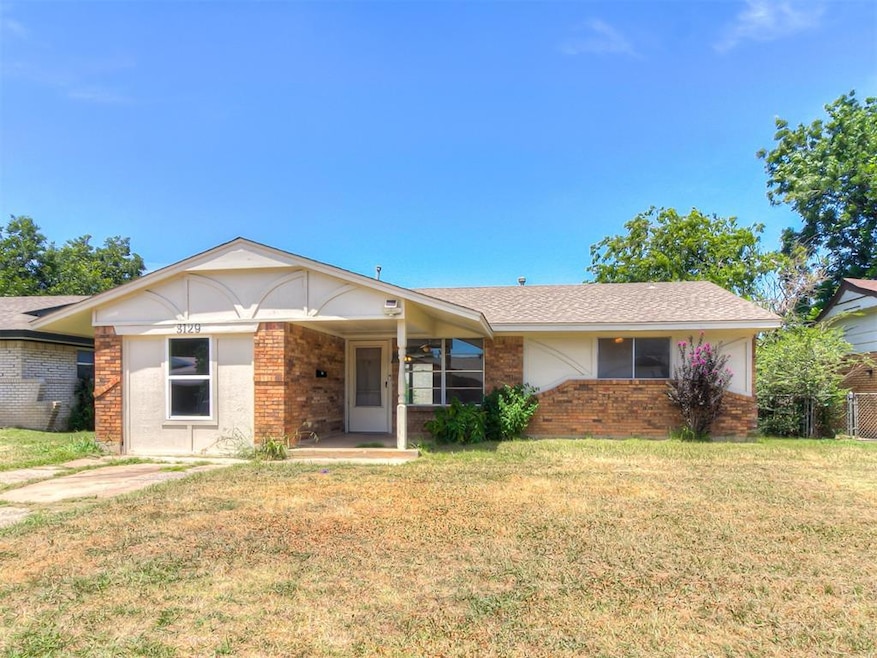 Ranch-style home with a front yard