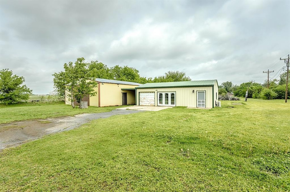 Rear view of house with a lawn, aphalt driveway, f