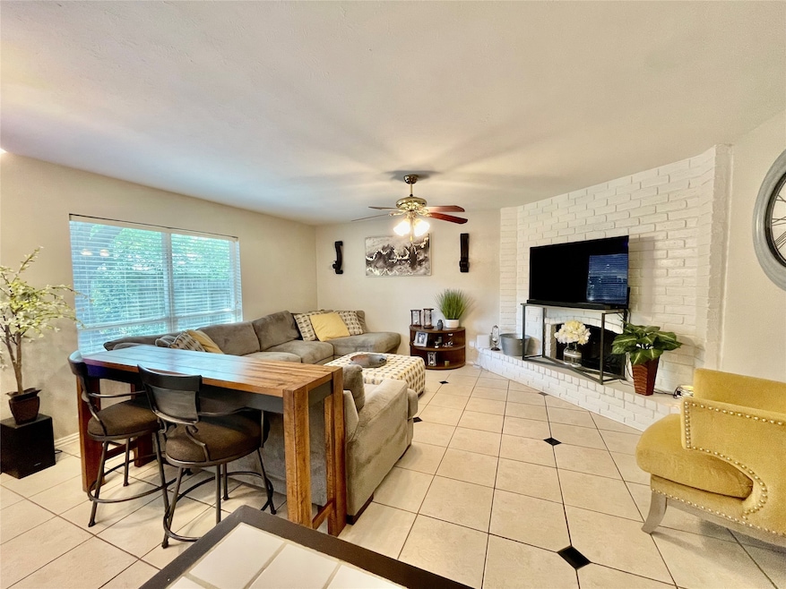 Open concept. Spacious living room. Natural light coming in the window. Ceiling fan.