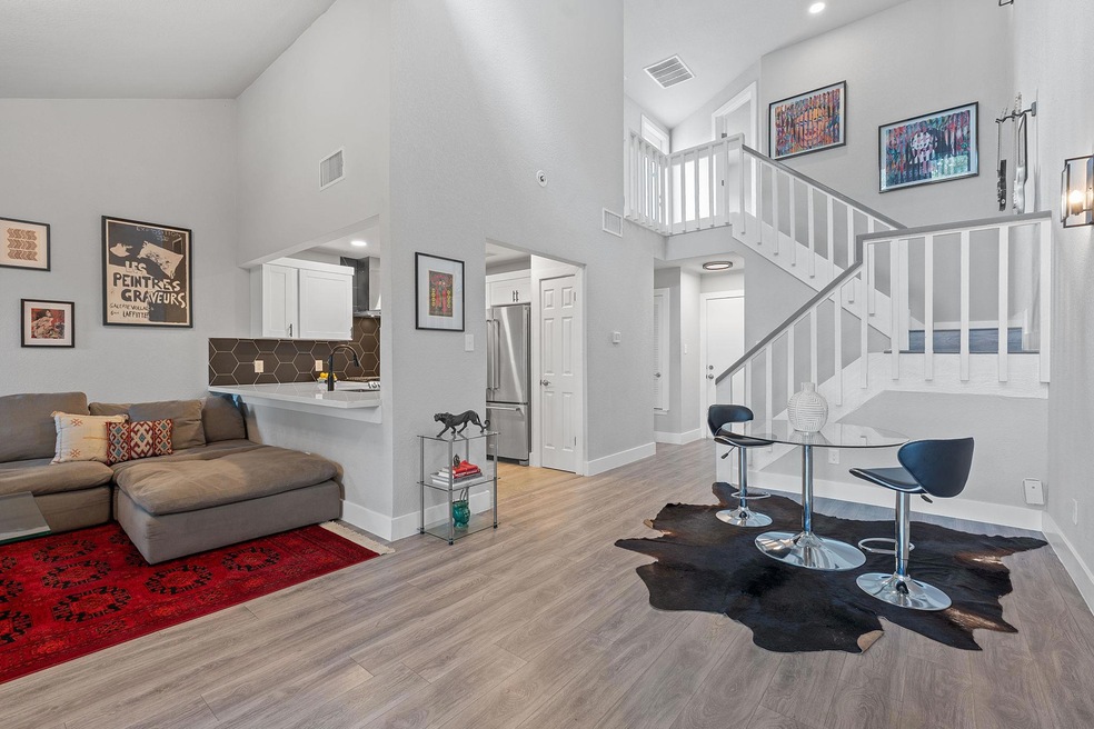 Living room with visible vents, high vaulted ceil