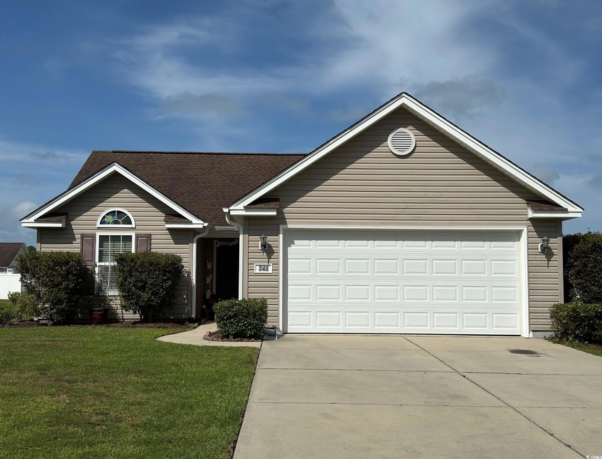 Single story home with a garage and a front yard