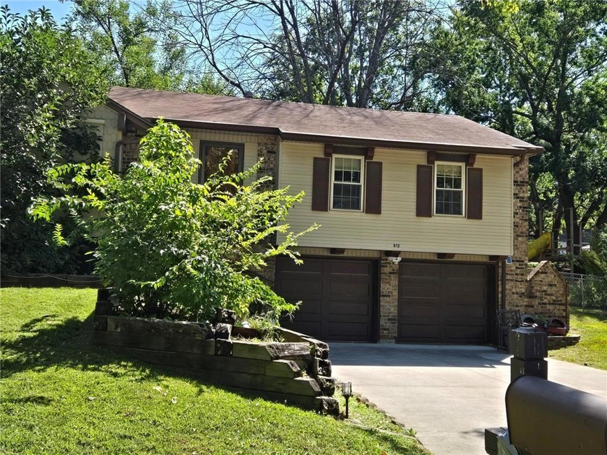 View of front facade featuring a garage and a front yard