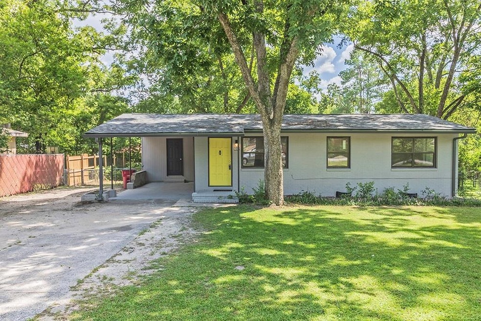 Single story home with a carport and a front lawn