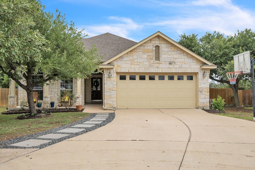 View of front of home with stone siding, a shingl