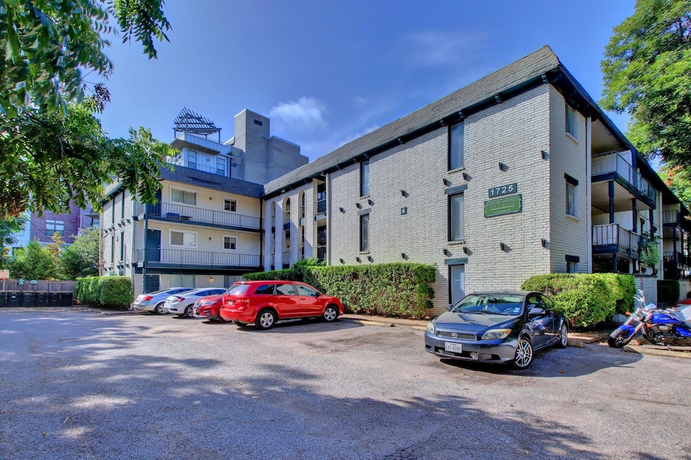 View of property featuring uncovered parking