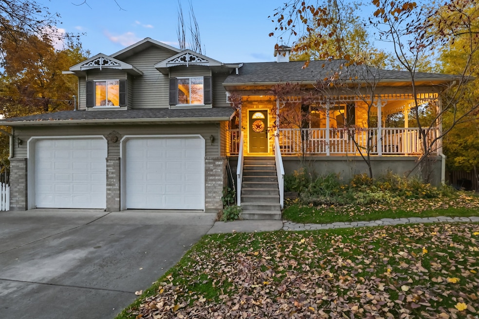 View of front of house featuring a porch, driveway, and an attached garage