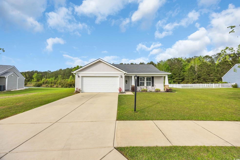 Single story home featuring concrete driveway, a f