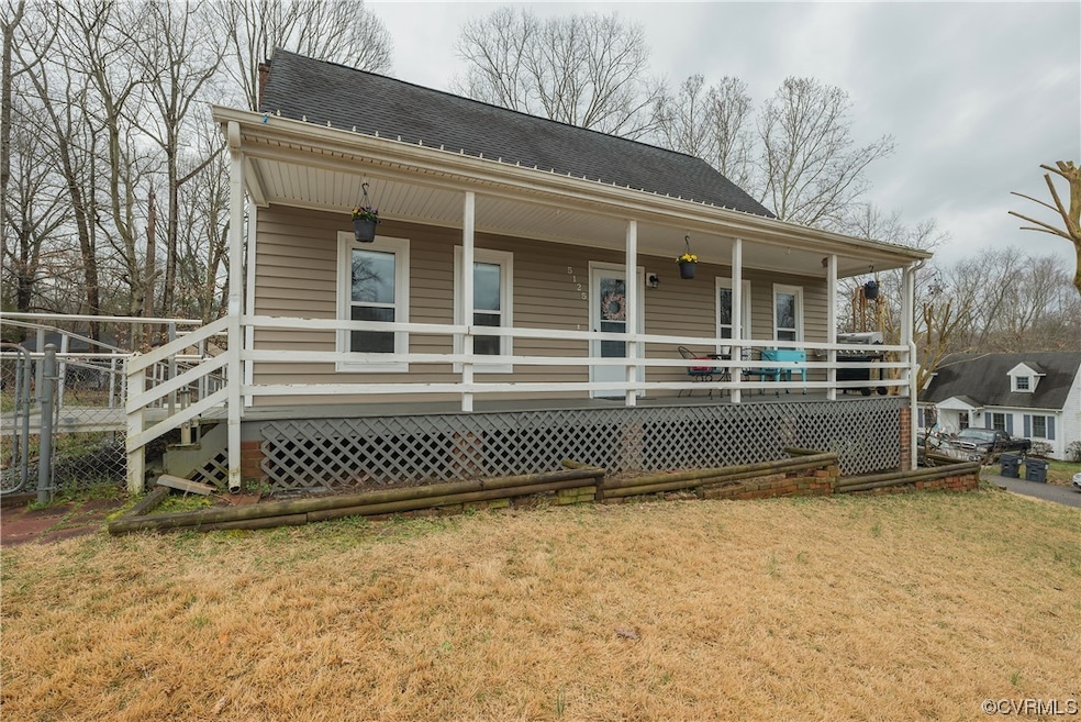 Rear view of property featuring covered porch and