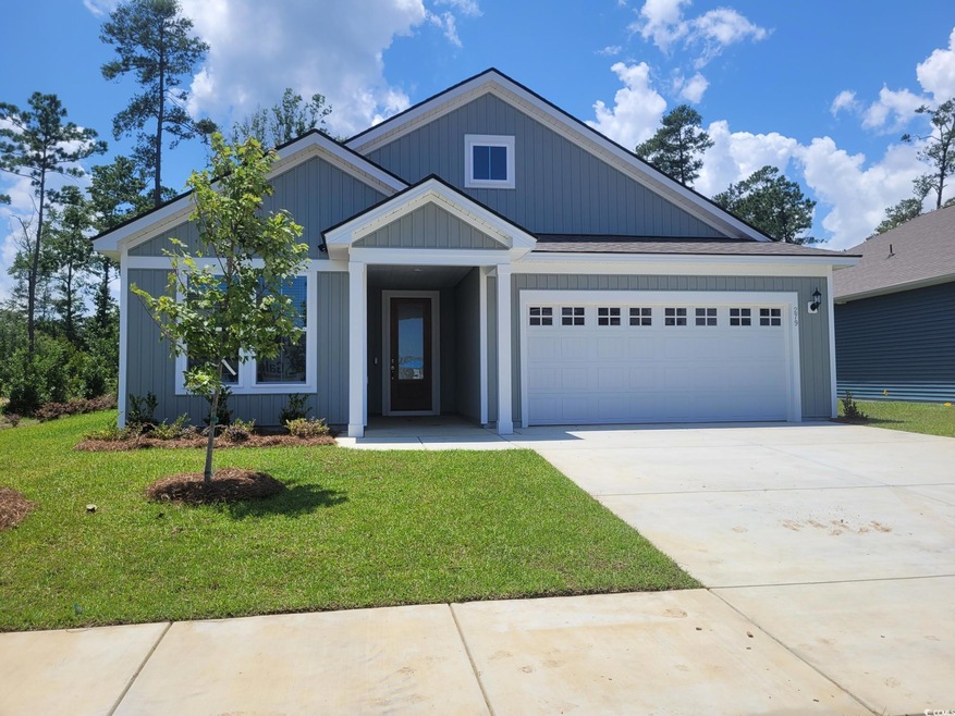 View of front of property with a garage, a front yard, and concrete driveway
