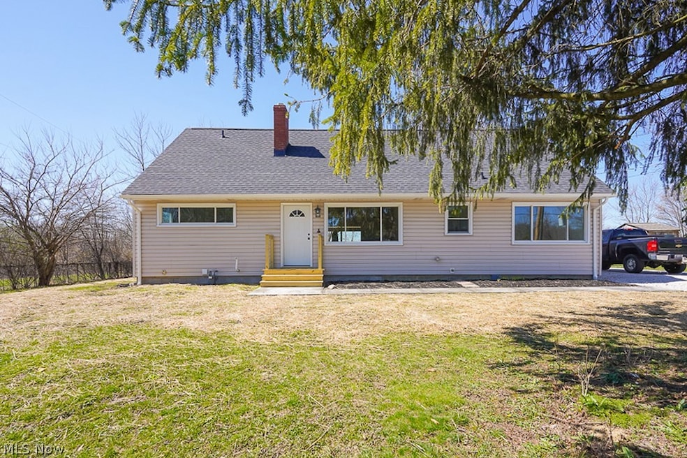 Ranch-style home featuring a front lawn