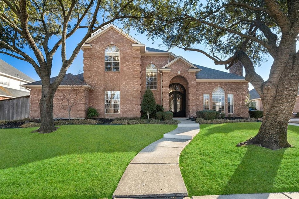 2009 Tarrant Lane has so much curb appeal with a spacious front yard and two large oak trees that perfectly the home.