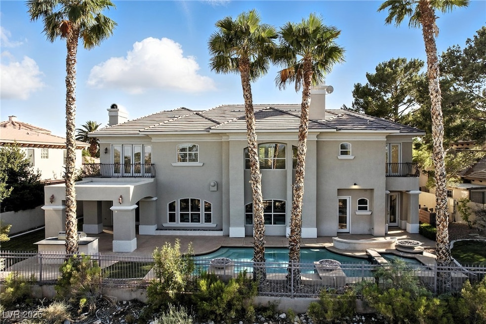 Rear view of property featuring a balcony, a chimn