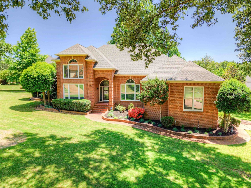 Traditional-style home featuring brick siding, a front yard, and roof with shingles