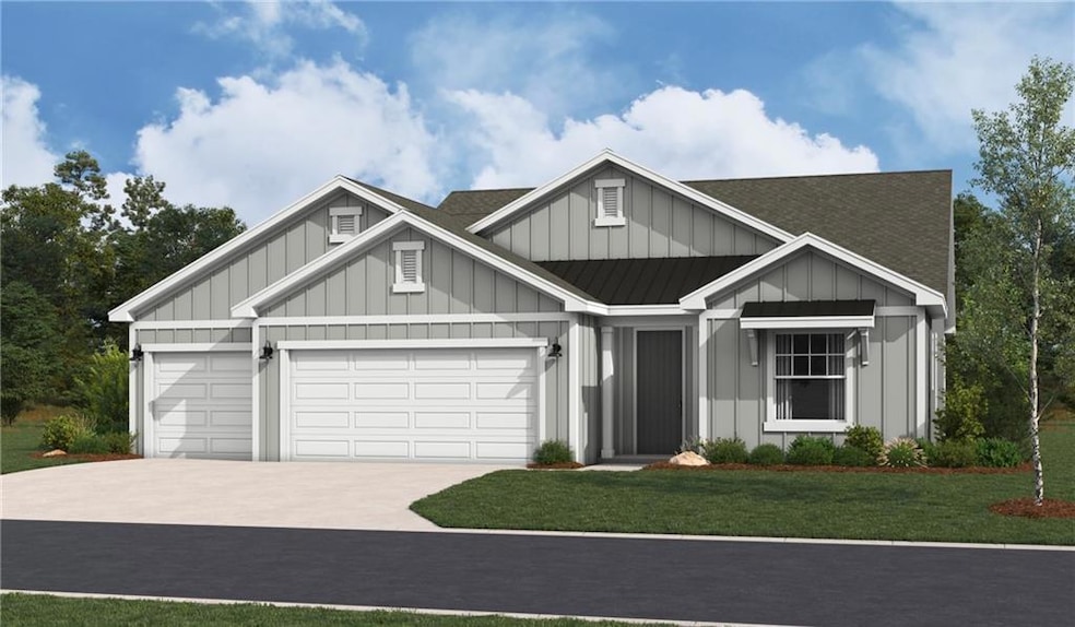 View of front of property featuring board and batten siding, an attached garage, driveway, a front yard, and roof with shingles