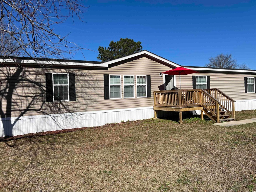 Exterior space featuring a wooden deck and a front