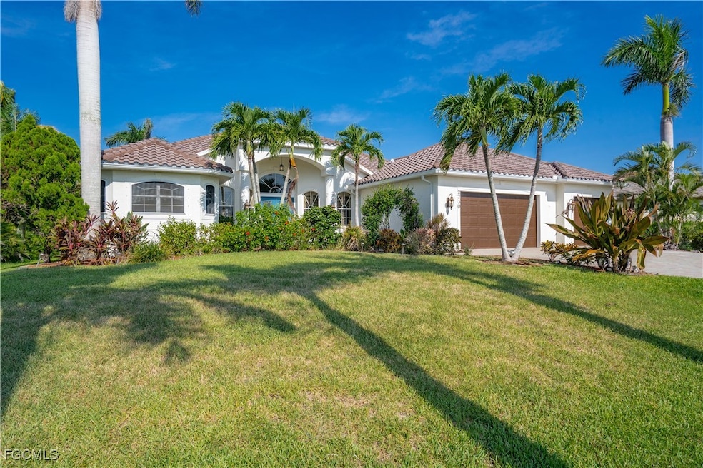 Mediterranean / spanish home featuring a tiled roof, stucco siding, a garage, and a front yard