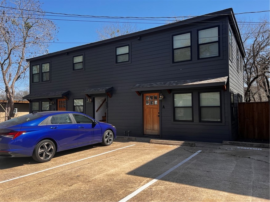 View of front of home featuring fence and uncovere