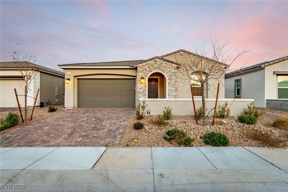 Ranch-style home featuring stone siding, stucco si