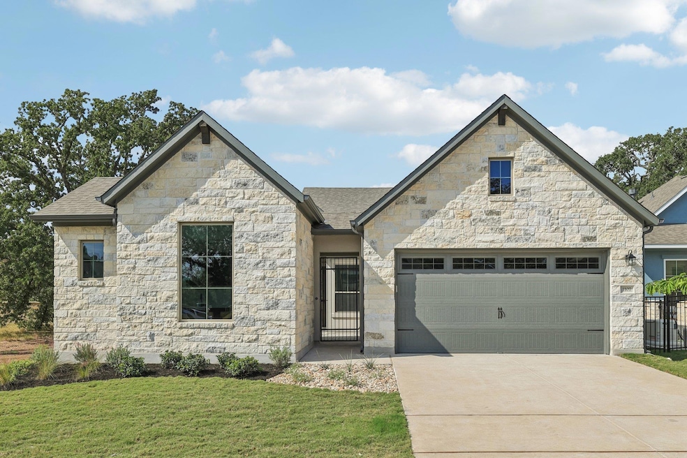 French provincial home with stone siding, concrete driveway, an attached garage, and a shingled roof