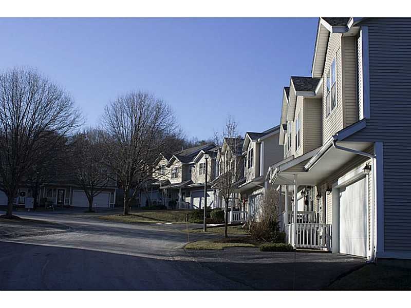 Exterior Front. Row of condos leading into the com