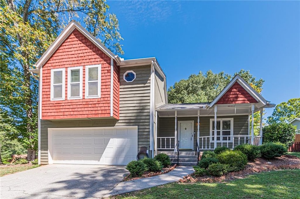 View of front of house with a garage and a porch