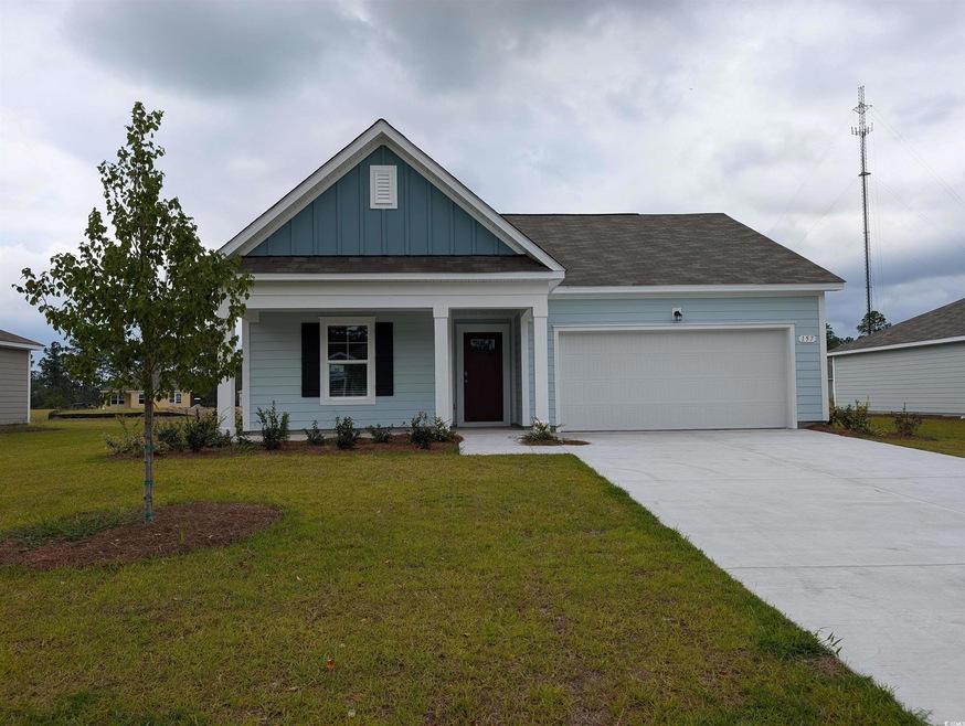 View of front of house featuring a garage, a porch