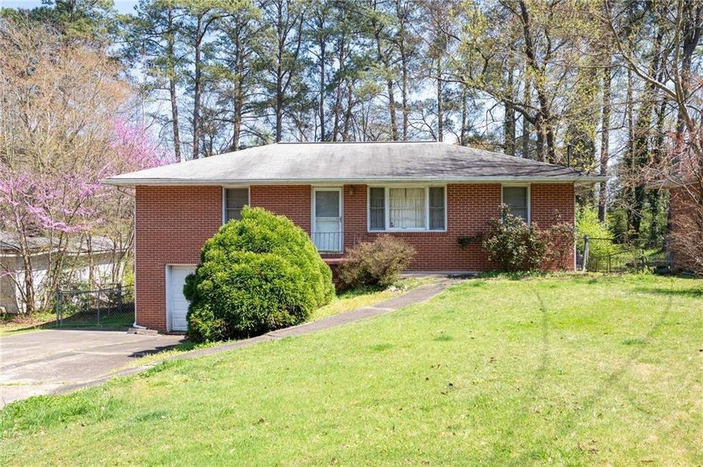 Ranch-style house with a front lawn and a garage