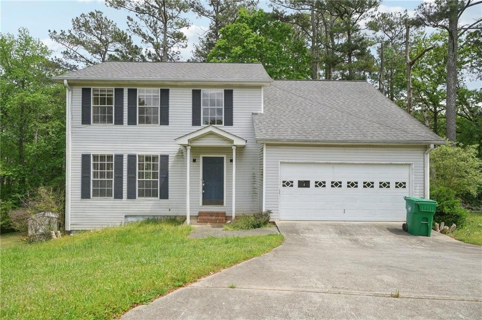 Colonial-style house featuring concrete driveway, 