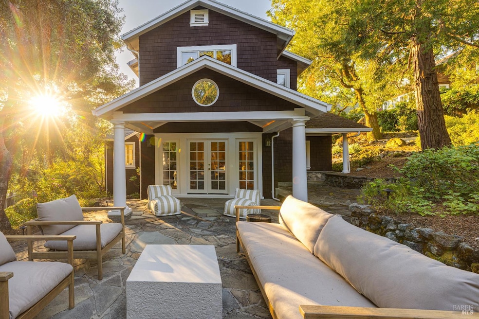 Morning sun showcases the beauty of this custom home among the trees.