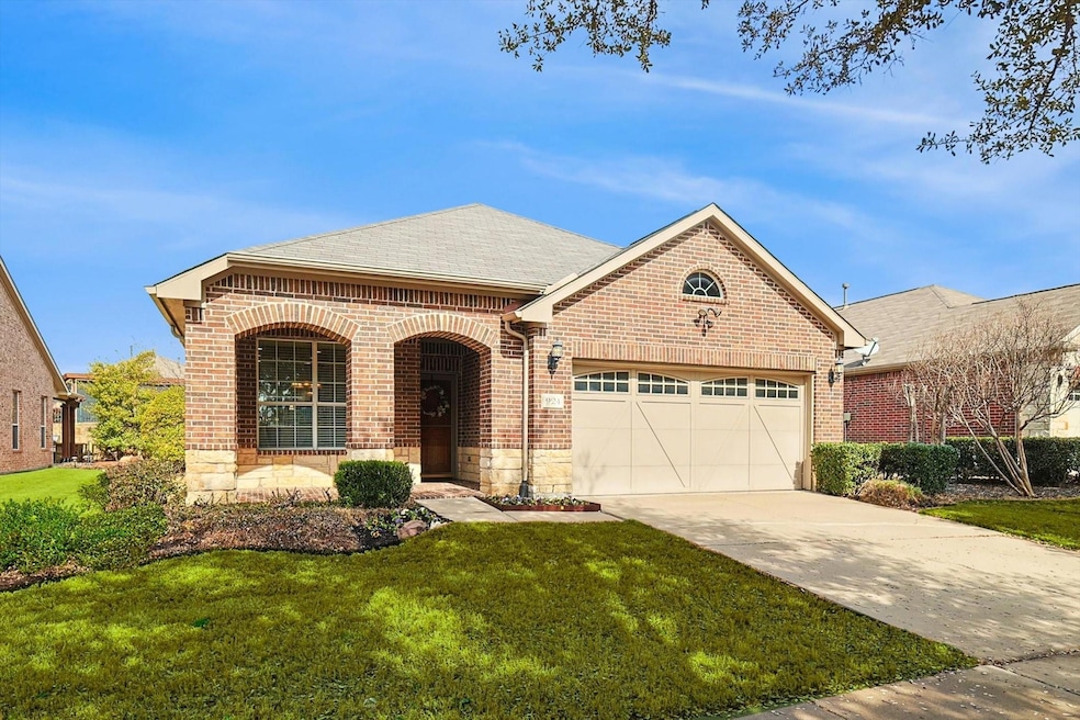 View of front of house with a front yard and a gar