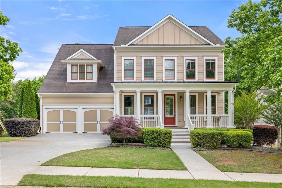 View of front facade featuring a front yard, a gar