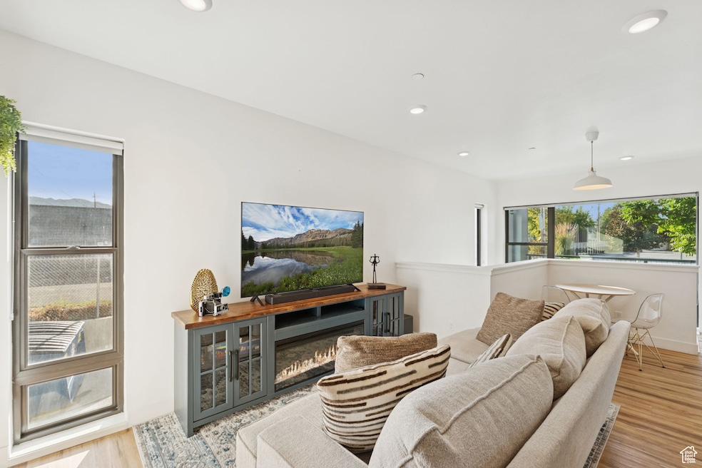 Living room with wood finished floors and recessed lighting