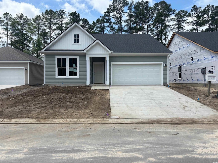 View of front facade featuring concrete driveway and a garage