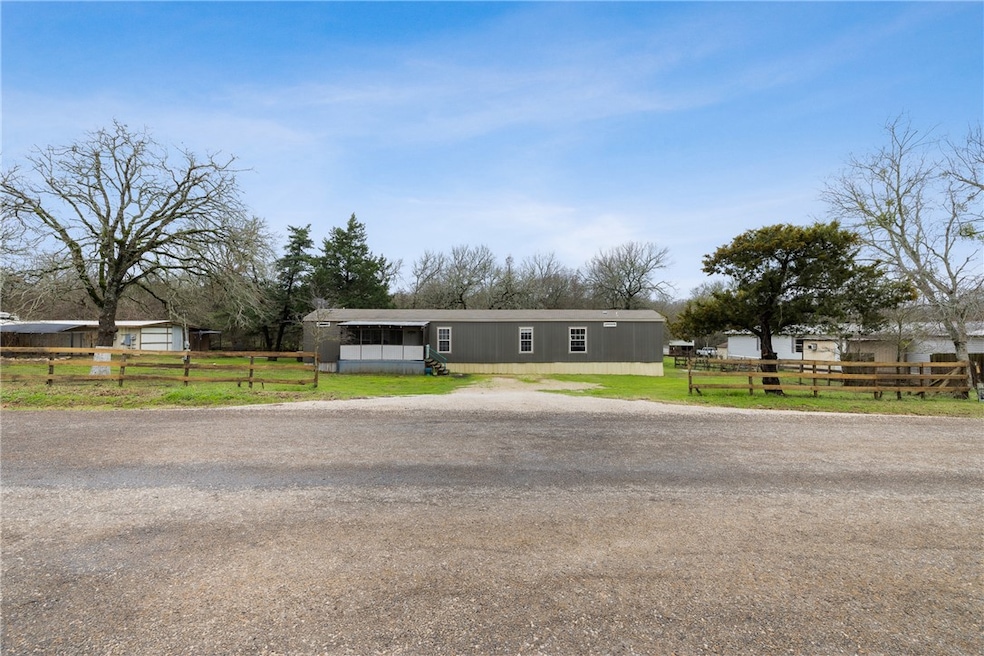 View of front of home featuring fence and a front