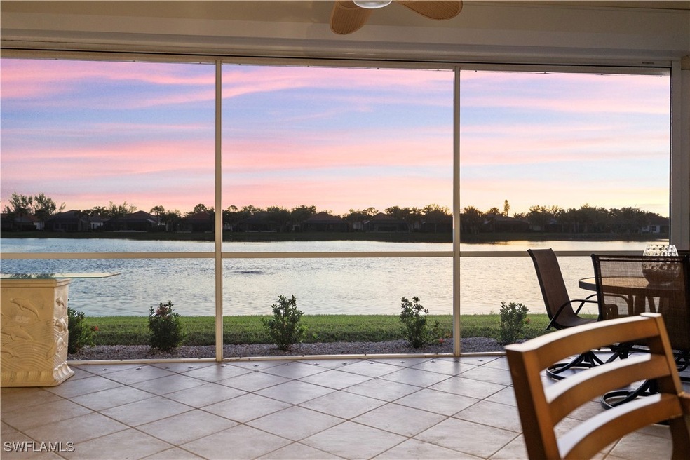 sunroom featuring ceiling fan, a water view, and a