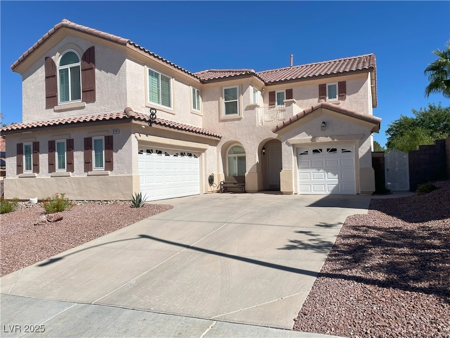 Mediterranean / spanish-style home featuring stucco siding, concrete driveway, a tile roof, and a garage