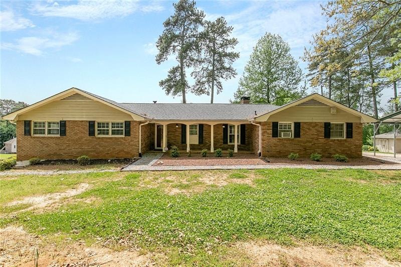 Front view of home with rocking chair front porch