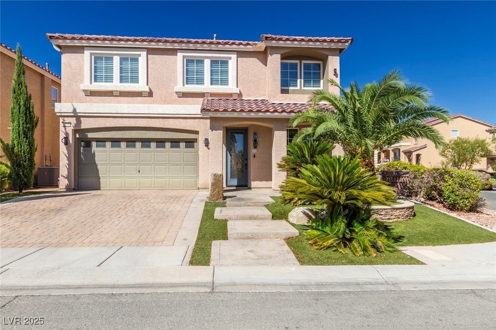 Mediterranean / spanish house featuring stucco siding, decorative driveway, a garage, and a tile roof
