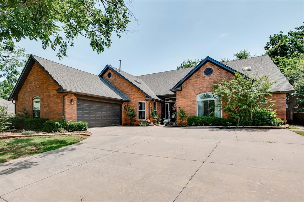 View of front facade with brick siding, a shingled roof, an attached garage, and driveway