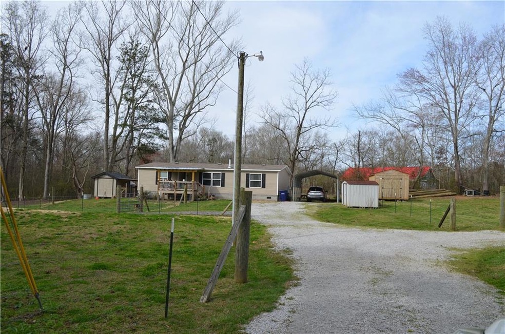 View of front of house featuring a storage unit an