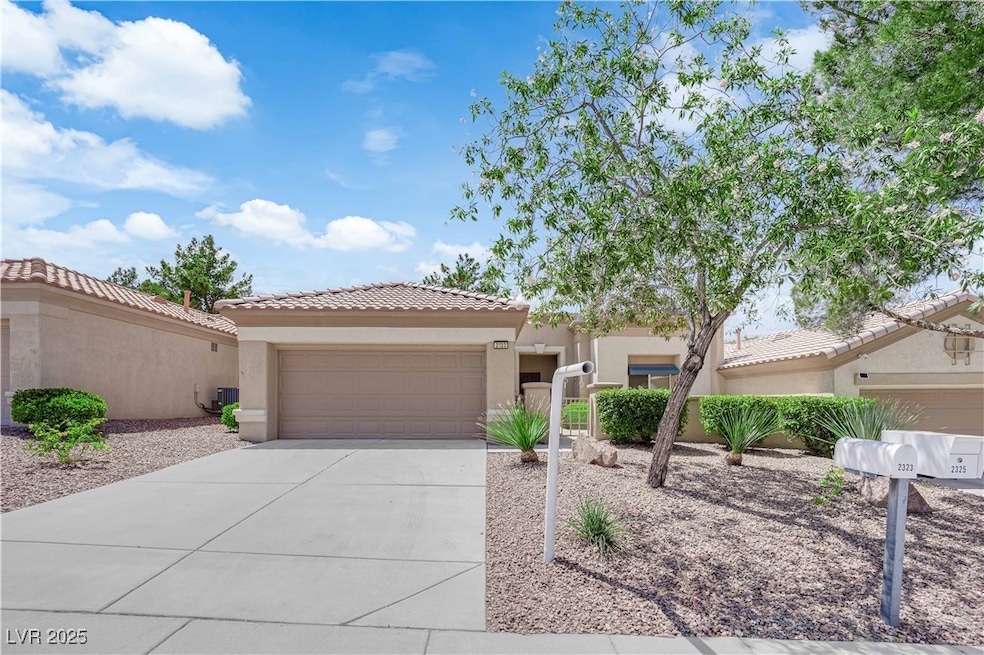 View of front facade featuring driveway, stucco si