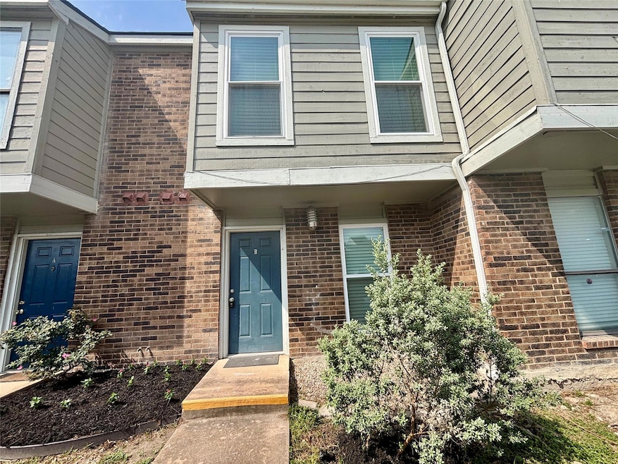 View of exterior entry featuring brick siding