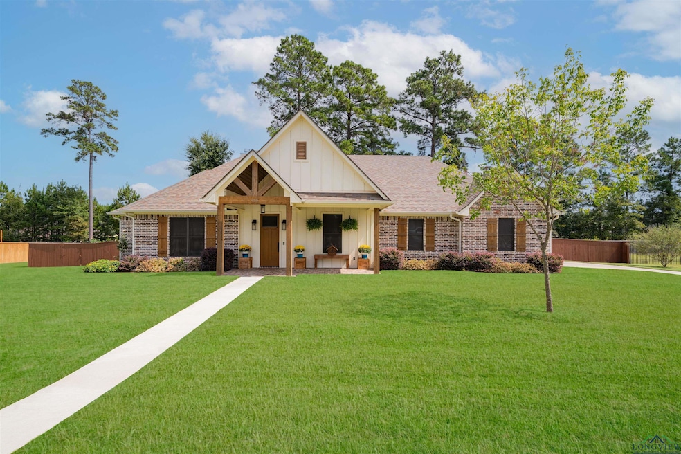 Modern farmhouse featuring board and batten siding, a porch, and a shingled roof