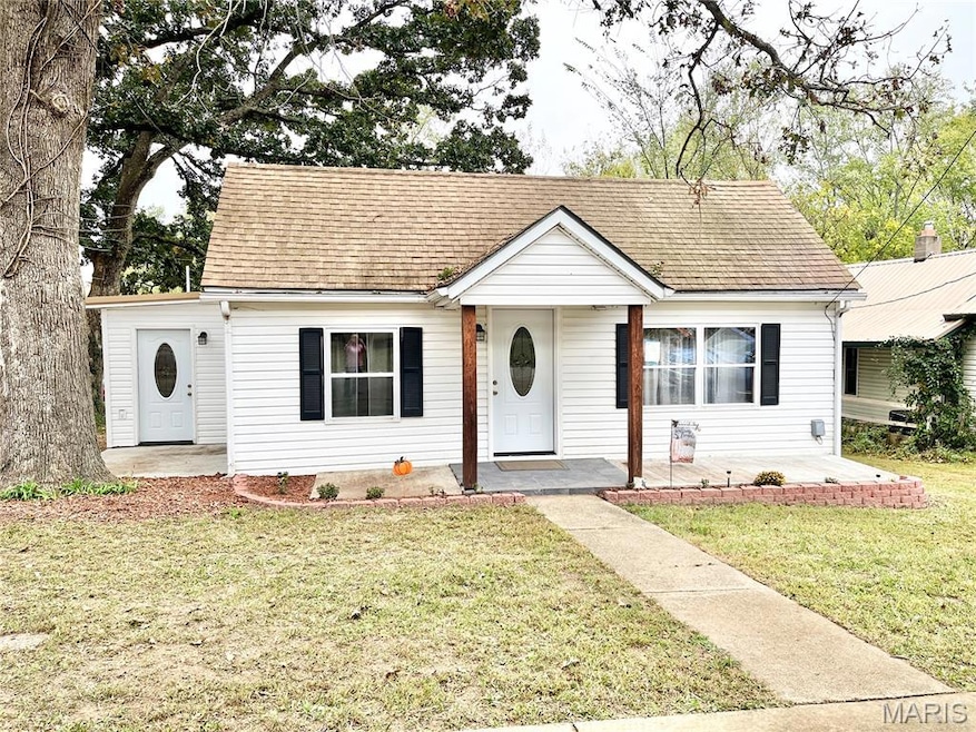 Bungalow-style house featuring a front lawn and a shingled roof