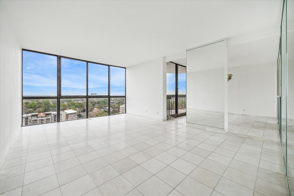 Living room with floor to ceiling windows.