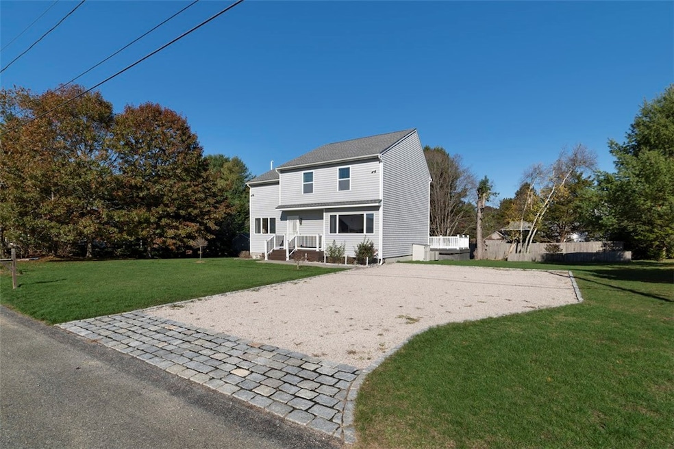 Front exterior with large driveway and spacious ya