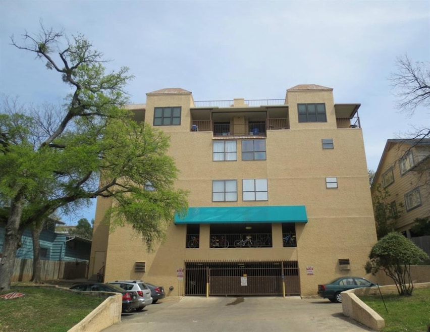 View of property featuring uncovered parking